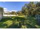 Spacious backyard with a large grassy area and a covered patio at 13589 Se 100Th Ave, Belleview, FL 34420