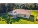 House's backyard with covered patio and grassy area at 13589 Se 100Th Ave, Belleview, FL 34420
