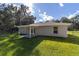House exterior and covered patio area overlooking the backyard at 13589 Se 100Th Ave, Belleview, FL 34420