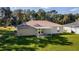 Backyard view of a house with a covered patio at 13589 Se 100Th Ave, Belleview, FL 34420