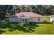 House's backyard featuring a covered patio and lawn at 13589 Se 100Th Ave, Belleview, FL 34420