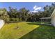 Large backyard with grassy area, trees, and a partially visible fence at 13589 Se 100Th Ave, Belleview, FL 34420