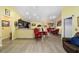 Bright dining area with a marble table, red velvet chairs, and hardwood floors at 13589 Se 100Th Ave, Belleview, FL 34420