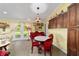 Bright dining area with a round table, red chairs, and a chandelier at 13589 Se 100Th Ave, Belleview, FL 34420