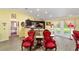 Charming dining area with a marble table, red velvet chairs, and hardwood floors at 13589 Se 100Th Ave, Belleview, FL 34420