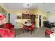 Charming dining area with a round table and red velvet chairs at 13589 Se 100Th Ave, Belleview, FL 34420