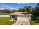 Single-story house with attached garage and a well-maintained lawn at 13589 Se 100Th Ave, Belleview, FL 34420