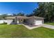 House with a white garage door and a well-kept lawn at 13589 Se 100Th Ave, Belleview, FL 34420