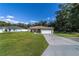 Single-story house with a garage and well-maintained lawn at 13589 Se 100Th Ave, Belleview, FL 34420