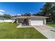 Single-story house with a garage and a landscaped front yard at 13589 Se 100Th Ave, Belleview, FL 34420