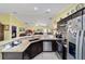 Open kitchen boasts granite counters, stainless steel appliances, and breakfast bar at 13589 Se 100Th Ave, Belleview, FL 34420