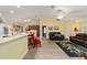 Open living area with hardwood floors, leather sofas, and a view of the kitchen at 13589 Se 100Th Ave, Belleview, FL 34420