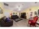 Living area featuring leather sofas, a ceiling fan, and a view of the kitchen at 13589 Se 100Th Ave, Belleview, FL 34420