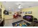 Spacious living room featuring hardwood floors, a ceiling fan, and comfortable leather furniture at 13589 Se 100Th Ave, Belleview, FL 34420