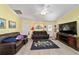 Spacious living room with leather sofas, large TV, and decorative rug at 13589 Se 100Th Ave, Belleview, FL 34420