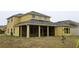 Rear view of a two-story house featuring a large screened porch at 369 James Cir, Lake Alfred, FL 33850