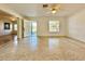 Spacious living room with terrazzo floors and ceiling fan at 1609 S Page Dr, Deltona, FL 32725