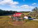Aerial view of a house with a red roof, pool, and expansive property at 20690 Sw 36Th St, Dunnellon, FL 34431