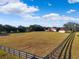 Aerial view showcasing a home on spacious grounds with a long fence at 20690 Sw 36Th St, Dunnellon, FL 34431