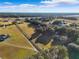 Aerial view of a property with a house, long driveway, and trees at 20690 Sw 36Th St, Dunnellon, FL 34431