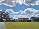 House with red roof and expansive green lawn at 20690 Sw 36Th St, Dunnellon, FL 34431