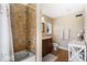 Bathroom with a shower/tub combo, vanity with dark wood cabinets, and a white toilet at 20690 Sw 36Th St, Dunnellon, FL 34431