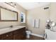 Bathroom with a single sink vanity, toilet, and a decorative mirror at 20690 Sw 36Th St, Dunnellon, FL 34431