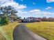 Curved driveway leading to a two-story home with red roof at 20690 Sw 36Th St, Dunnellon, FL 34431