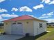 Detached garage with a red metal roof and white siding at 20690 Sw 36Th St, Dunnellon, FL 34431