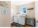 Laundry room with washer, dryer, and a vintage-style cabinet at 20690 Sw 36Th St, Dunnellon, FL 34431