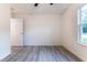 Bedroom with ceiling fan and window, featuring wood-look floors at 8873 Sw 139Th Place Rd, Ocala, FL 34473