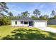 Newly constructed home with gray exterior, a blue door, and a two-car garage at 8873 Sw 139Th Place Rd, Ocala, FL 34473