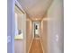 Long hallway with light walls and wood flooring at 103 13Th Se St, Winter Haven, FL 33880