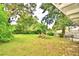 Large backyard with mature trees and grassy area at 103 13Th Se St, Winter Haven, FL 33880