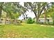 Large backyard with mature trees and grassy area at 103 13Th Se St, Winter Haven, FL 33880