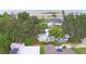 Wide aerial view of the house and neighborhood, showing surrounding homes and trees at 103 13Th Se St, Winter Haven, FL 33880