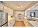Full view of kitchen with white cabinets and stainless steel appliances at 103 13Th Se St, Winter Haven, FL 33880