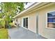 Spacious back patio with sliding glass doors and two chairs at 103 13Th Se St, Winter Haven, FL 33880