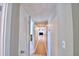 Hallway with wood-look floors leading to living room at 103 13Th Se St, Winter Haven, FL 33880
