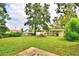 Large backyard with mature trees and grassy area at 103 13Th Se St, Winter Haven, FL 33880