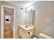 Bathroom with vanity, sink, toilet and mirror at 103 13Th Se St, Winter Haven, FL 33880