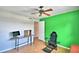 Bedroom with green accent wall, desk, and gaming chair at 103 13Th Se St, Winter Haven, FL 33880