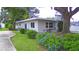 Side view of the house showcasing the backyard and lush landscaping at 103 13Th Se St, Winter Haven, FL 33880
