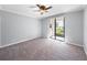 Bright bedroom with sliding glass doors leading to a lake view at 301 Laurel Cove Way # 111, Winter Haven, FL 33884