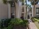 Condo entrance with lush tropical landscaping at 301 Laurel Cove Way # 111, Winter Haven, FL 33884