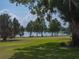 Serene lake view from the property with oak trees at 301 Laurel Cove Way # 111, Winter Haven, FL 33884