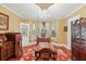 Elegant dining room with hardwood floors, built-in hutch, and chandelier at 350 E Park Ave, Lake Wales, FL 33853