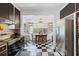 Retro kitchen with stainless steel appliances and black and white checkered floors at 350 E Park Ave, Lake Wales, FL 33853