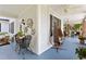 Large front porch with light blue floors, wicker furniture, and hanging lights at 350 E Park Ave, Lake Wales, FL 33853