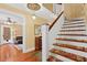 Grand entryway with hardwood floors, antique staircase, and view into living room at 350 E Park Ave, Lake Wales, FL 33853